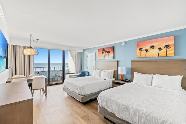 7100 N Ocean Blvd N Unit 601, Myrtle Beach, SC 29572 - bedroom with a water view, ornamental molding, light wood-type flooring, access to outside, and a wall of windows