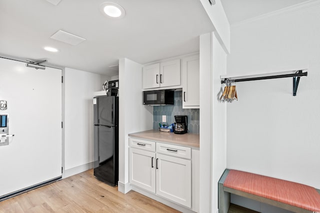 7100 N Ocean Blvd N Unit 601, Myrtle Beach, SC 29572 - kitchen with black appliances, white cabinets, backsplash, light wood finished floors, and recessed lighting