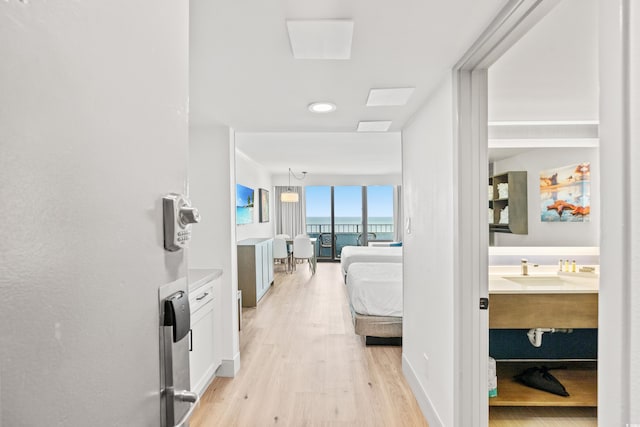 7100 N Ocean Blvd N Unit 601, Myrtle Beach, SC 29572 - hallway with light wood-type flooring, a sink, and a water view