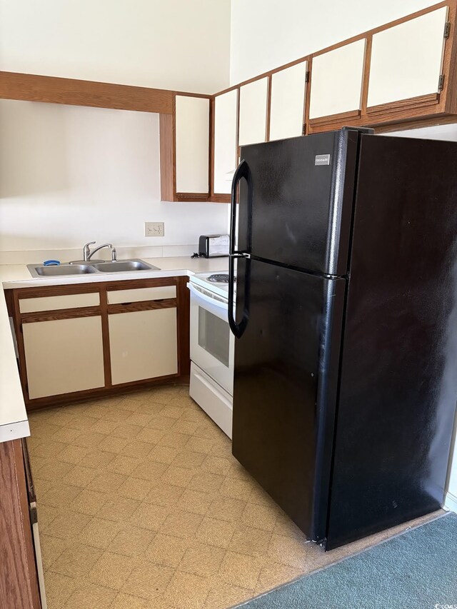1930 Bent Grass Dr Unit 39H, Surfside Beach, SC 29575 - kitchen with freestanding refrigerator, white electric stove, light countertops, a sink, and white cabinets