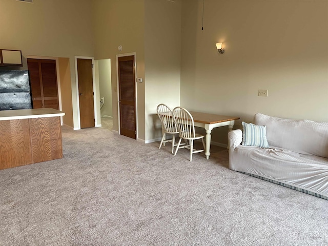 1930 Bent Grass Dr Unit 39H, Surfside Beach, SC 29575 - living area featuring a towering ceiling, carpet, and baseboards