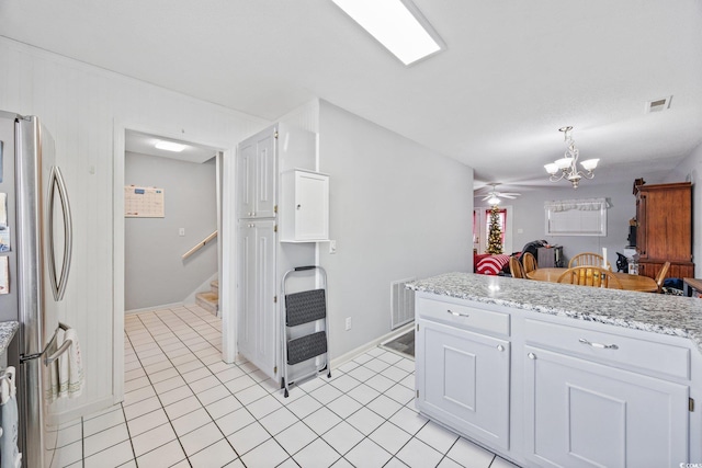 775 Plantation Dr Unit 28, Little River, SC 29566 - kitchen featuring freestanding refrigerator, a chandelier, light tile patterned flooring, and white cabinets