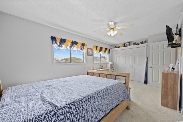 775 Plantation Dr Unit 28, Little River, SC 29566 - bedroom with light colored carpet, a closet, a ceiling fan, and a textured ceiling