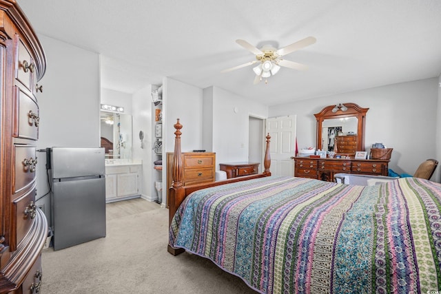 775 Plantation Dr Unit 28, Little River, SC 29566 - bedroom featuring freestanding refrigerator, light carpet, ensuite bath, and a ceiling fan