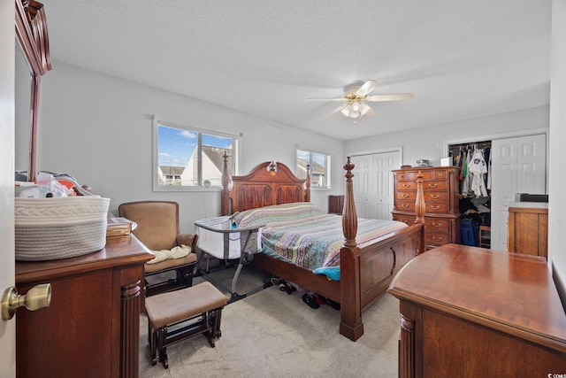 775 Plantation Dr Unit 28, Little River, SC 29566 - bedroom with light colored carpet, multiple closets, ceiling fan, and a desk