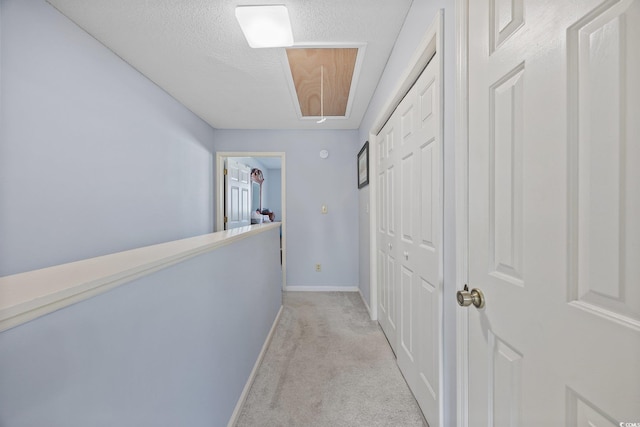 775 Plantation Dr Unit 28, Little River, SC 29566 - hallway with light carpet, attic access, and a textured ceiling