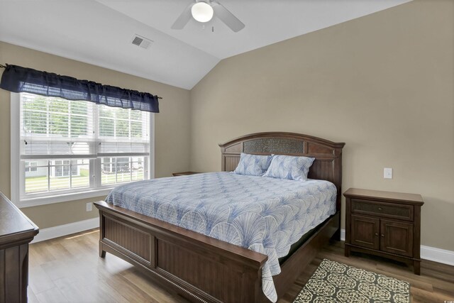 8855 Radcliff Dr NW Unit 53C, Calabash, NC 28467 - bedroom featuring wood finished floors, vaulted ceiling, baseboards, and ceiling fan