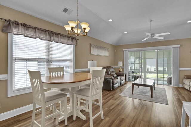 8855 Radcliff Dr NW Unit 53C, Calabash, NC 28467 - dining area featuring lofted ceiling, a chandelier, wood finished floors, a ceiling fan, and baseboards