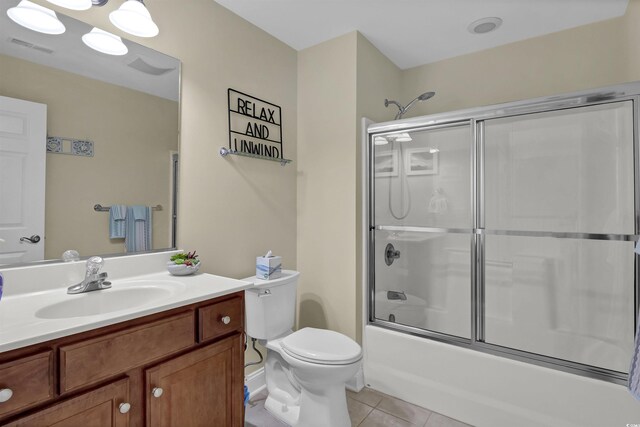 8855 Radcliff Dr NW Unit 53C, Calabash, NC 28467 - full bathroom featuring vanity, toilet, tile patterned flooring, and bath / shower combo with glass door