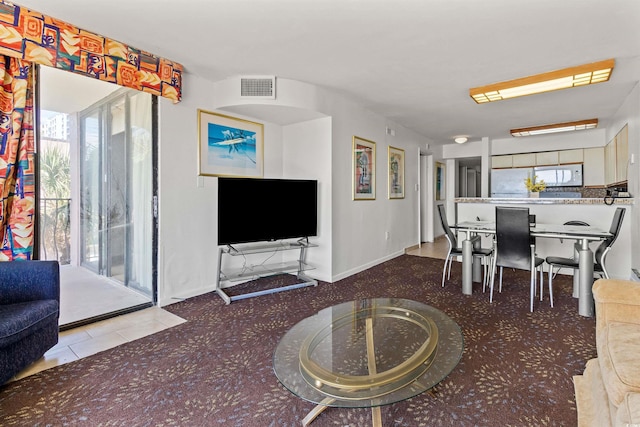 2500 N Ocean Blvd Unit 102, Myrtle Beach, SC 29577 - carpeted living area with healthy amount of natural light, baseboards, and tile patterned flooring