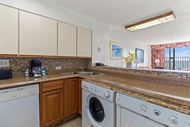 2500 N Ocean Blvd Unit 102, Myrtle Beach, SC 29577 - laundry area with washer and dryer and light tile patterned floors