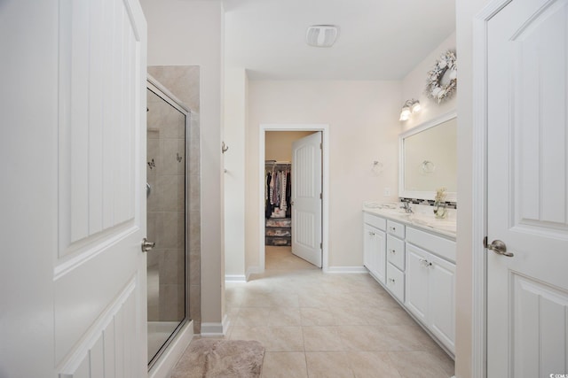 924 Sorano St, Myrtle Beach, SC 29579 - bathroom featuring double vanity, a shower stall, a spacious closet, and tile patterned floors