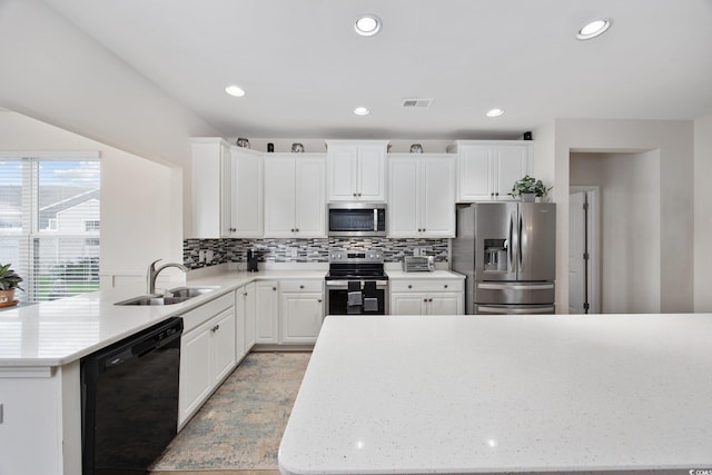 924 Sorano St, Myrtle Beach, SC 29579 - kitchen with appliances with stainless steel finishes, decorative backsplash, a peninsula, white cabinets, and recessed lighting