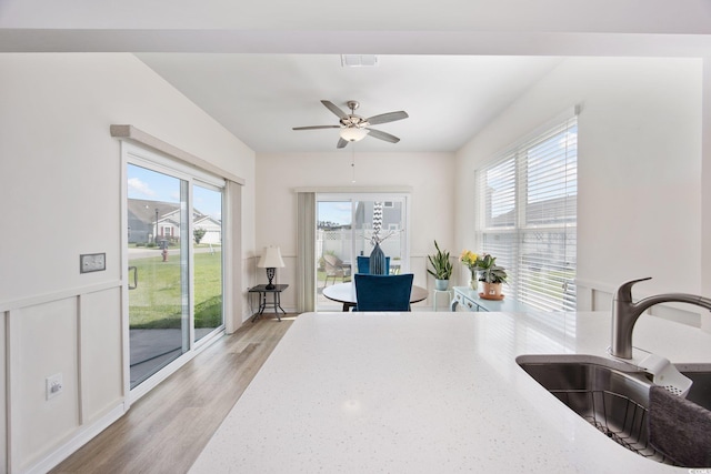 924 Sorano St, Myrtle Beach, SC 29579 - kitchen featuring ceiling fan, light wood-style flooring, and light stone counters
