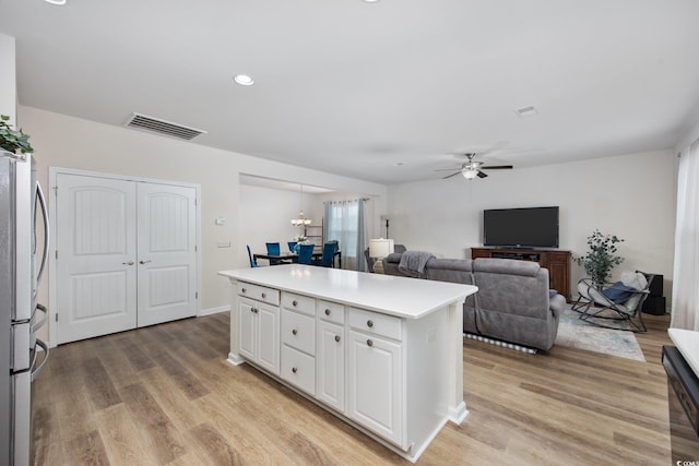 924 Sorano St, Myrtle Beach, SC 29579 - kitchen with white cabinetry, a kitchen island, ceiling fan, light wood finished floors, and recessed lighting