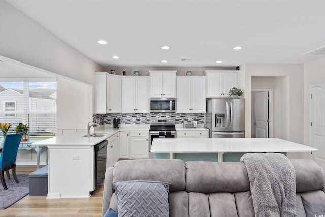 924 Sorano St, Myrtle Beach, SC 29579 - kitchen with stainless steel appliances, open floor plan, light wood-style flooring, light countertops, and recessed lighting