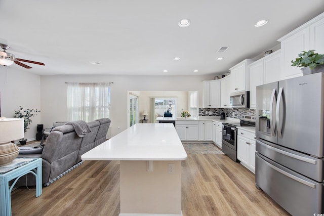 924 Sorano St, Myrtle Beach, SC 29579 - kitchen featuring appliances with stainless steel finishes, open floor plan, ceiling fan, light wood-style floors, and light countertops