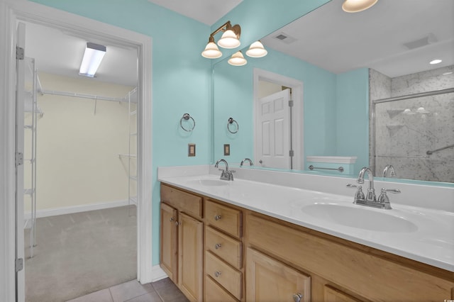 8855 Radcliff Dr NW Unit 53D, Calabash, NC 28467 - full bath with a stall shower, double vanity, tile patterned flooring, and a walk in closet