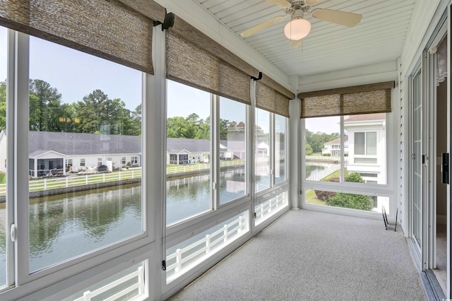 8855 Radcliff Dr NW Unit 53D, Calabash, NC 28467 - unfurnished sunroom featuring a water view, ceiling fan, and a residential view