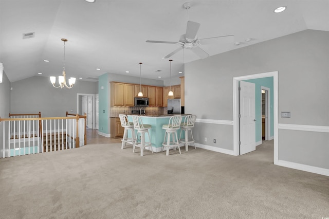 8855 Radcliff Dr NW Unit 53D, Calabash, NC 28467 - kitchen with stainless steel appliances, vaulted ceiling, recessed lighting, a chandelier, and a ceiling fan