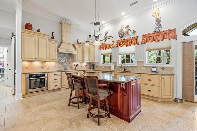 784 Caines Landing Rd, Conway, SC 29526 - kitchen with oven, a sink, ornamental molding, custom exhaust hood, and cream cabinetry