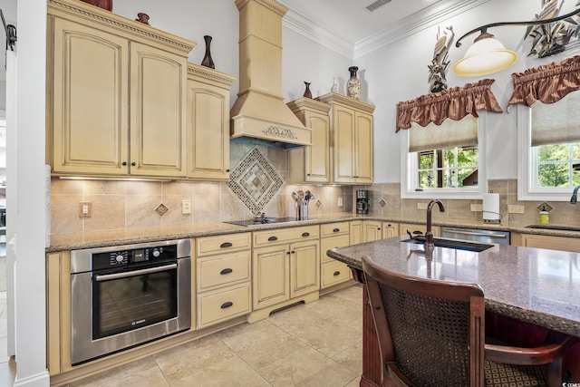 784 Caines Landing Rd, Conway, SC 29526 - kitchen featuring oven, cream cabinetry, custom range hood, black electric stovetop, and ornamental molding