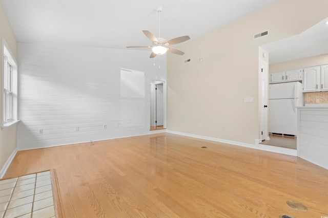 814 Night Heron Ln, Myrtle Beach, SC 29572 - unfurnished living room featuring light wood-type flooring, a ceiling fan, and baseboards