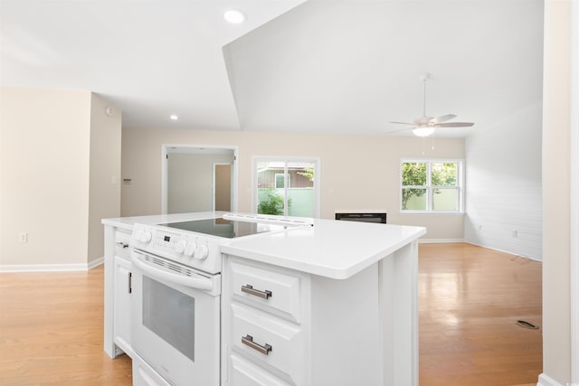 814 Night Heron Ln, Myrtle Beach, SC 29572 - kitchen featuring white range with electric cooktop, light wood finished floors, ceiling fan, baseboards, and white cabinetry