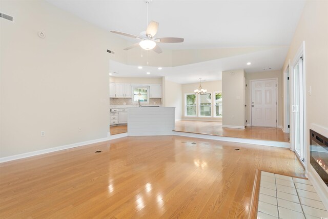 814 Night Heron Ln, Myrtle Beach, SC 29572 - unfurnished living room with lofted ceiling, a chandelier, a ceiling fan, light wood-style flooring, and recessed lighting