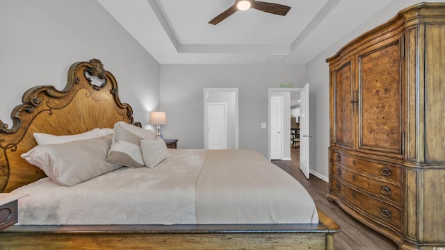 4053 Taranto Loop Unit C, Myrtle Beach, SC 29579 - bedroom featuring a tray ceiling, dark wood-style flooring, and a ceiling fan