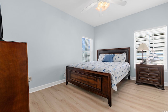 3401 N Ocean Blvd Unit 110, North Myrtle Beach, SC 29582 - bedroom featuring wood finished floors, multiple windows, baseboards, and ceiling fan