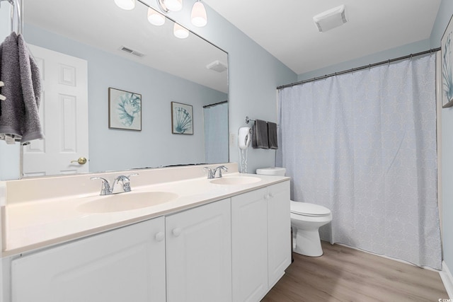 3401 N Ocean Blvd Unit 110, North Myrtle Beach, SC 29582 - full bathroom with wood finished floors, double vanity, and toilet
