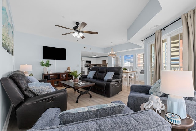 3401 N Ocean Blvd Unit 110, North Myrtle Beach, SC 29582 - living room featuring a chandelier, ceiling fan, and light wood finished floors