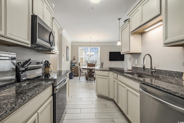 150 Ella Kinley Cir Unit 301, Myrtle Beach, SC 29588 - kitchen with stainless steel appliances, a sink, ornamental molding, a chandelier, and pendant lighting