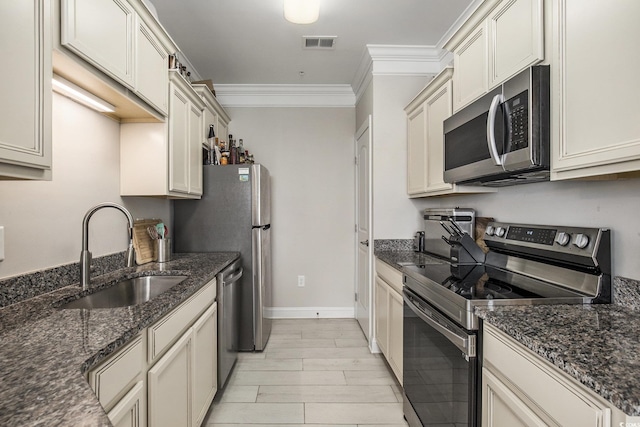150 Ella Kinley Cir Unit 301, Myrtle Beach, SC 29588 - kitchen featuring appliances with stainless steel finishes, a sink, ornamental molding, dark stone counters, and baseboards
