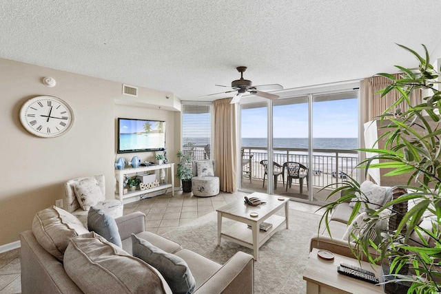 1625 S Ocean Blvd Unit 309, North Myrtle Beach, SC 29582 - living room featuring ceiling fan, floor to ceiling windows, a textured ceiling, and light tile patterned floors