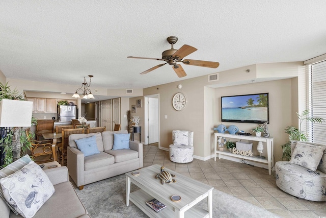 1625 S Ocean Blvd Unit 309, North Myrtle Beach, SC 29582 - living area with ceiling fan, light tile patterned flooring, a textured ceiling, a chandelier, and baseboards