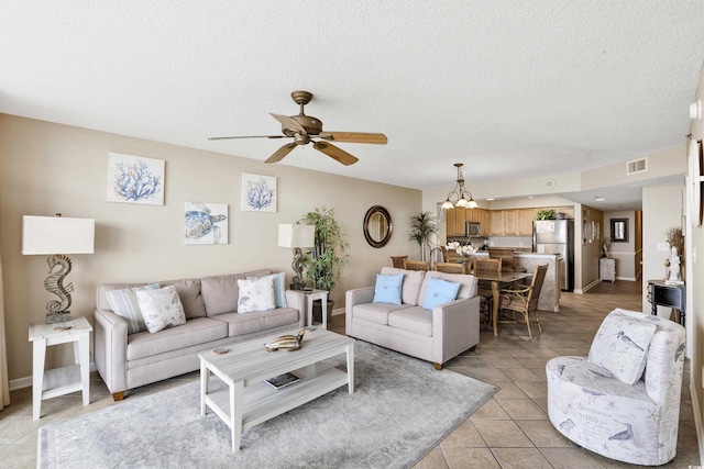1625 S Ocean Blvd Unit 309, North Myrtle Beach, SC 29582 - living room with light tile patterned flooring, ceiling fan, a textured ceiling, a chandelier, and baseboards