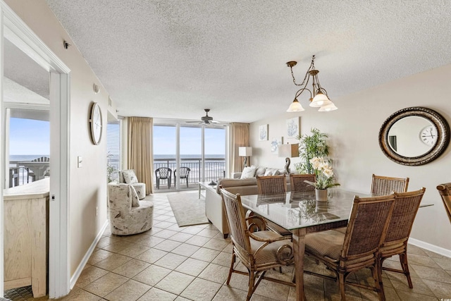 1625 S Ocean Blvd Unit 309, North Myrtle Beach, SC 29582 - dining room featuring a water view, a textured ceiling, ceiling fan, baseboards, and light tile patterned floors