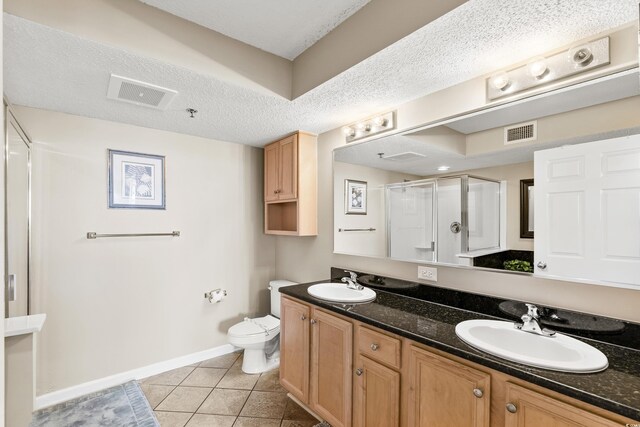 1625 S Ocean Blvd Unit 309, North Myrtle Beach, SC 29582 - full bath featuring double vanity, tile patterned floors, a shower stall, toilet, and baseboards