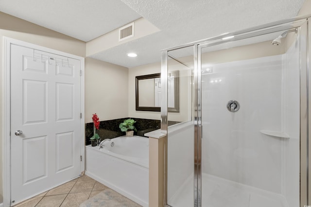 1625 S Ocean Blvd Unit 309, North Myrtle Beach, SC 29582 - full bathroom with a shower stall, a bath, tile patterned floors, and a textured ceiling