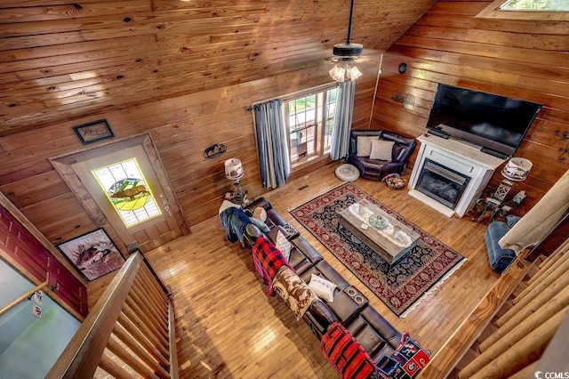 181 Halfway Rd, Nichols, SC 29581 - living area featuring wood walls, hardwood / wood-style floors, a glass covered fireplace, lofted ceiling, and wooden ceiling