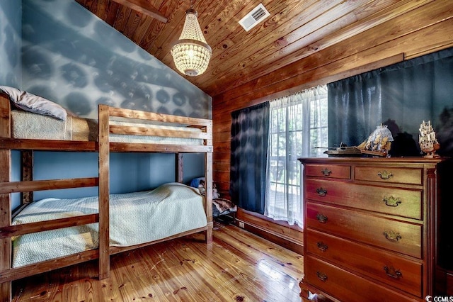 181 Halfway Rd, Nichols, SC 29581 - bedroom with vaulted ceiling, hardwood / wood-style flooring, a chandelier, wooden ceiling, and wood walls