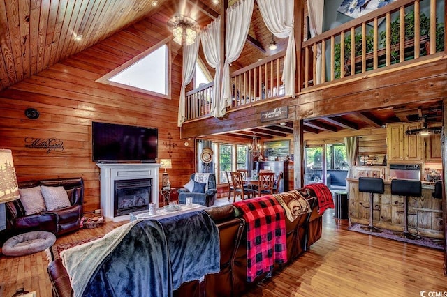 181 Halfway Rd, Nichols, SC 29581 - living area featuring healthy amount of natural light, high vaulted ceiling, wooden walls, wood ceiling with exposed beams, and a fireplace
