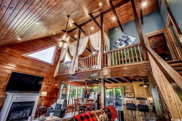181 Halfway Rd, Nichols, SC 29581 - living room with high vaulted ceiling, wooden walls, a skylight, wood ceiling, and a glass covered fireplace