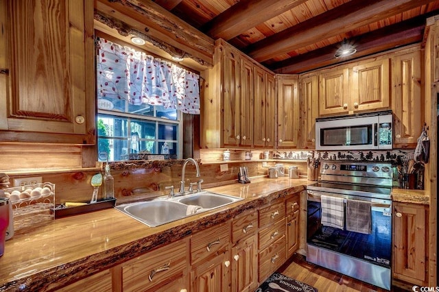 181 Halfway Rd, Nichols, SC 29581 - kitchen with appliances with stainless steel finishes, a sink, wooden ceiling with exposed beams, and wood finished floors