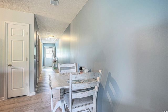 1460 Blue Tree Ct Unit E, Myrtle Beach, SC 29588 - dining room with a textured ceiling and light wood-style flooring