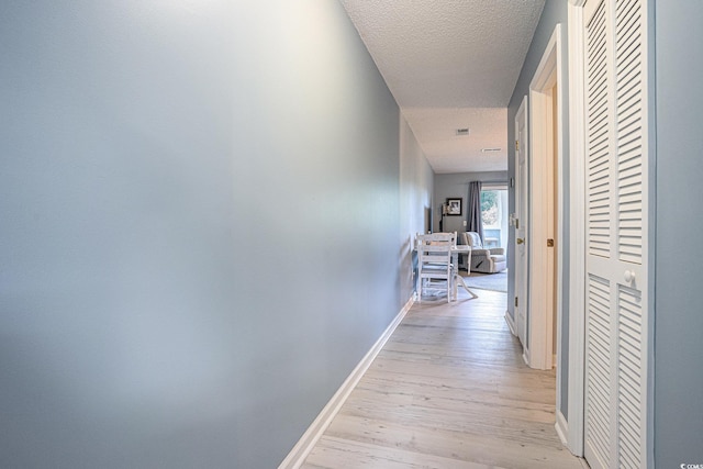 1460 Blue Tree Ct Unit E, Myrtle Beach, SC 29588 - hallway featuring light wood-type flooring and a textured ceiling