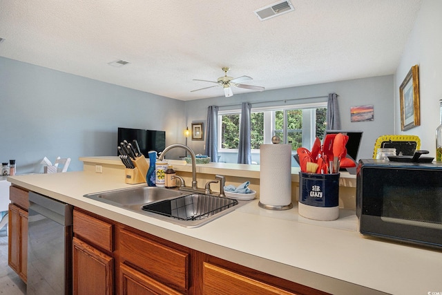 1460 Blue Tree Ct Unit E, Myrtle Beach, SC 29588 - kitchen featuring dishwasher, light countertops, a ceiling fan, open floor plan, and a textured ceiling