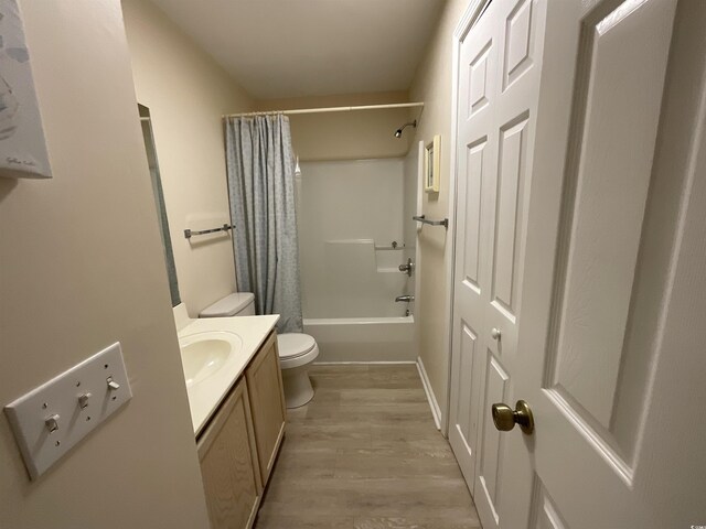 1900 Duffy St Unit L-5, North Myrtle Beach, SC 29582 - bathroom featuring toilet, vanity, wood finished floors, and shower / bathtub combination with curtain